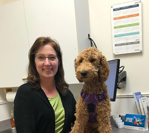 Zoetis veterinarian posing in exam room with dog