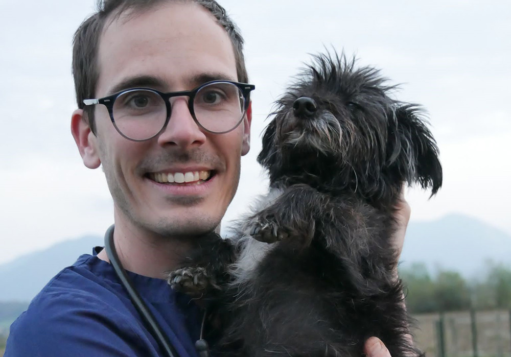 Zoetis veterinarian holding black dog