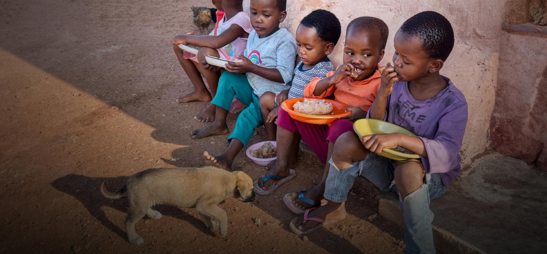 Children eating with puppy nearby - Zoetis